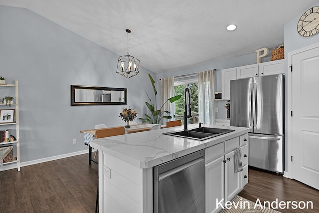 kitchen with white cabinets, appliances with stainless steel finishes, dark wood-style floors, and a sink