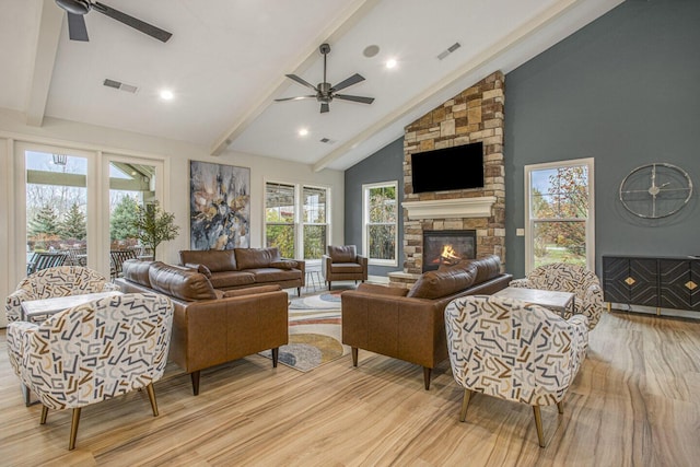 living room with light wood-style floors, ceiling fan, lofted ceiling with beams, and visible vents