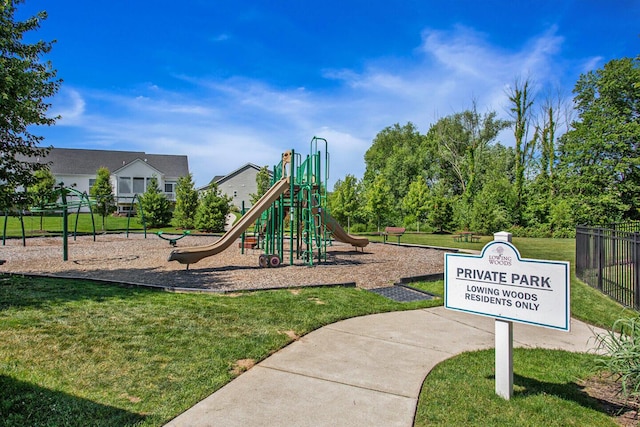 community jungle gym with fence and a yard