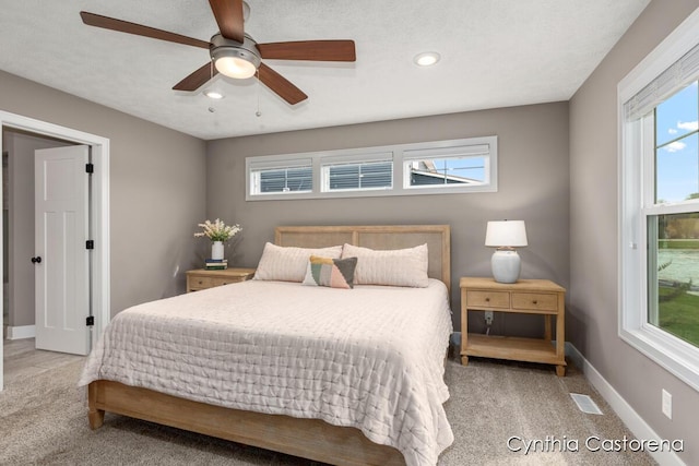 carpeted bedroom with recessed lighting, a ceiling fan, baseboards, and visible vents