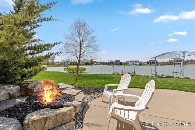 view of patio / terrace featuring a boat dock, a water view, and an outdoor fire pit