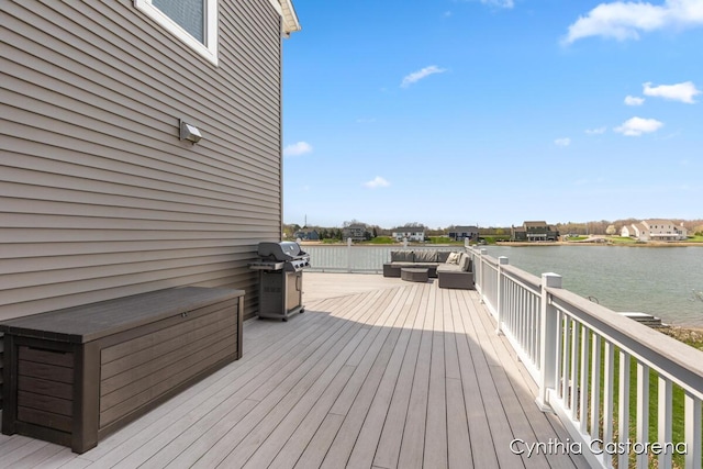 deck featuring a water view, an outdoor living space, and a grill