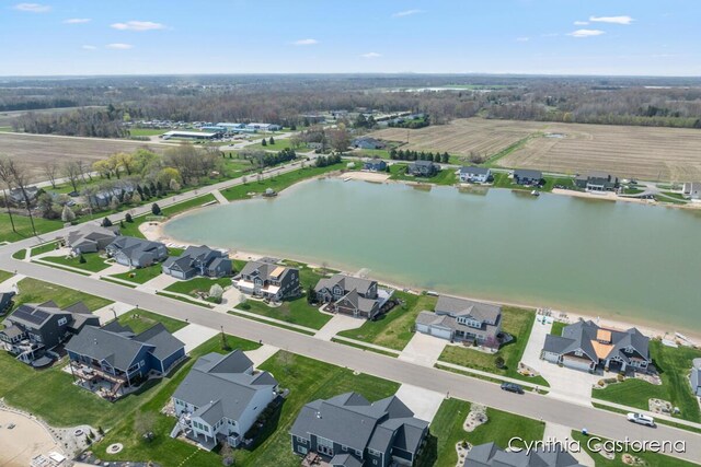 drone / aerial view with a water view and a residential view