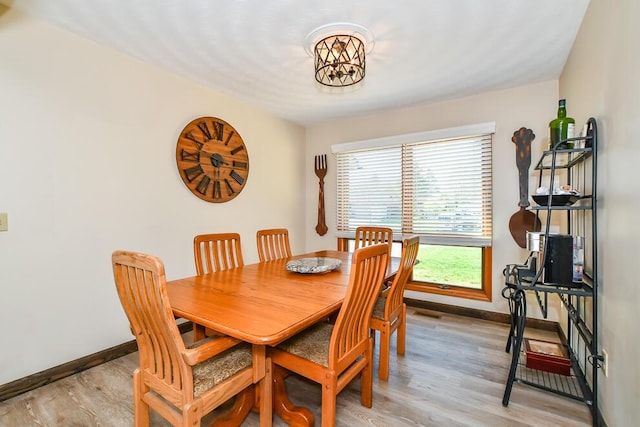 dining space with light wood-style floors, baseboards, and plenty of natural light
