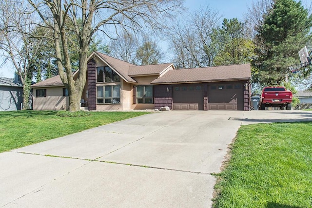view of front of house with concrete driveway, an attached garage, and a front lawn