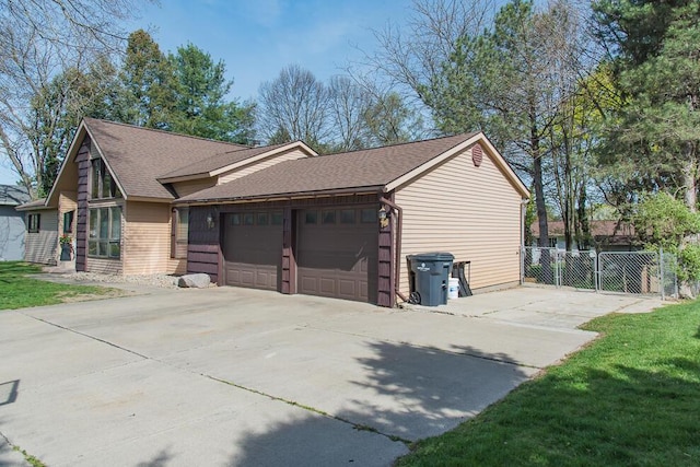 view of side of property with a garage, fence, concrete driveway, and roof with shingles