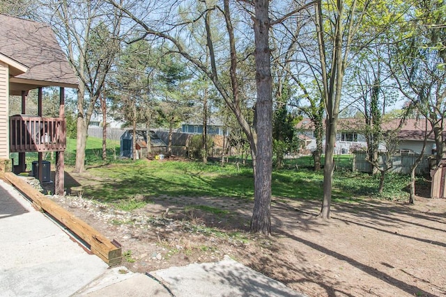 view of yard with fence and a deck