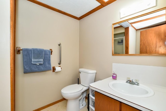 bathroom featuring vanity, ornamental molding, toilet, and a shower