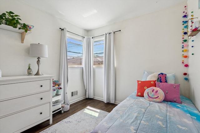 bedroom featuring baseboards, visible vents, and dark wood-type flooring