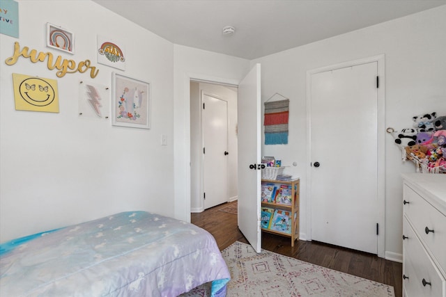 bedroom with baseboards and wood finished floors