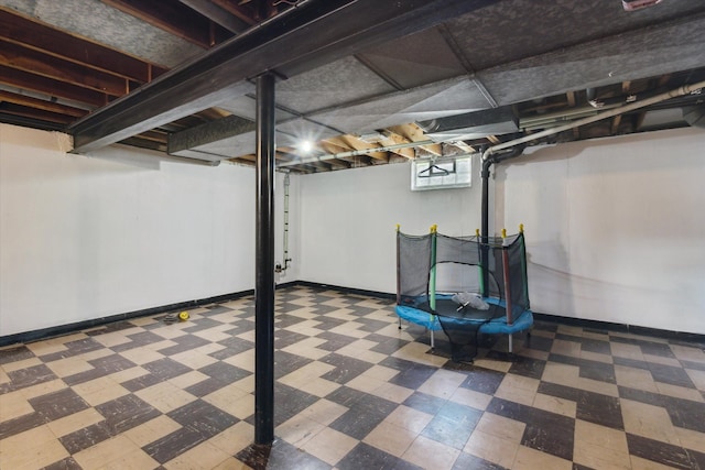 basement with baseboards and tile patterned floors