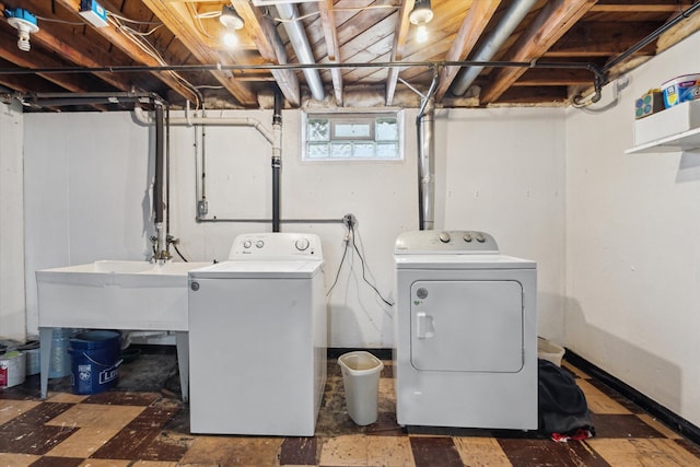 laundry room featuring separate washer and dryer, laundry area, and a sink