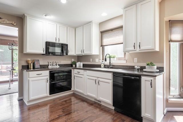 1229 Poppy Hill Dr, Oxford, MI 48371 - kitchen featuring a healthy amount of sunlight, dark countertops, and black appliances