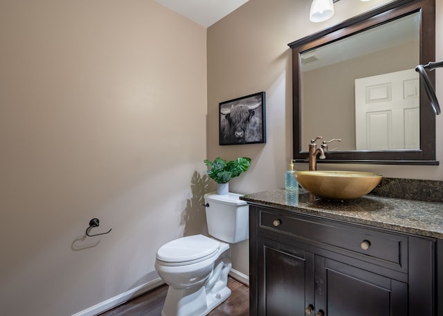 1229 Poppy Hill Dr, Oxford, MI 48371 - half bath with baseboards, wood finished floors, toilet, and vanity