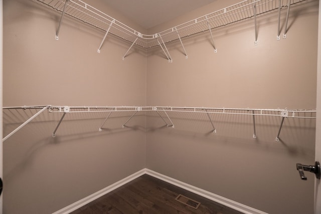 1229 Poppy Hill Dr, Oxford, MI 48371 - spacious closet with dark wood-style flooring and visible vents