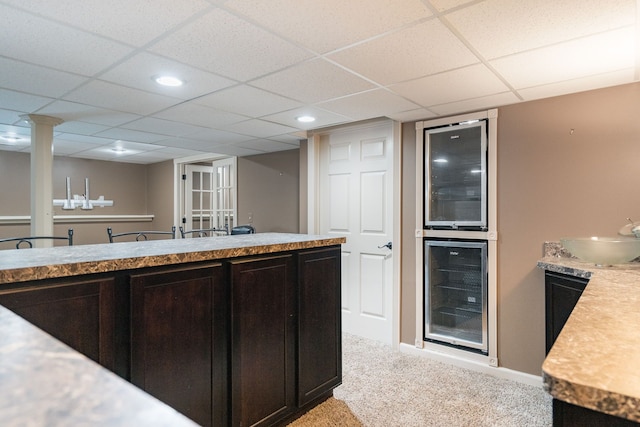 1229 Poppy Hill Dr, Oxford, MI 48371 - kitchen featuring light countertops, light carpet, a drop ceiling, and beverage cooler