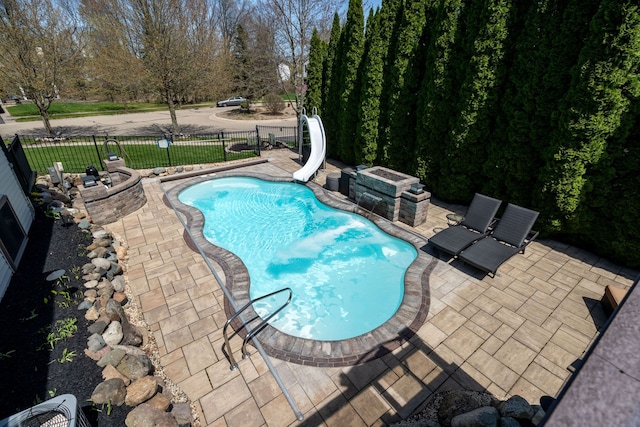 1229 Poppy Hill Dr, Oxford, MI 48371 - view of pool with a patio, a water slide, a fenced in pool, and fence