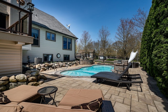 1229 Poppy Hill Dr, Oxford, MI 48371 - view of swimming pool with a fenced in pool, a water slide, central AC, and a patio area