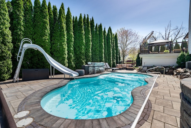 1229 Poppy Hill Dr, Oxford, MI 48371 - view of pool with a fenced in pool, a water slide, outdoor lounge area, and a patio