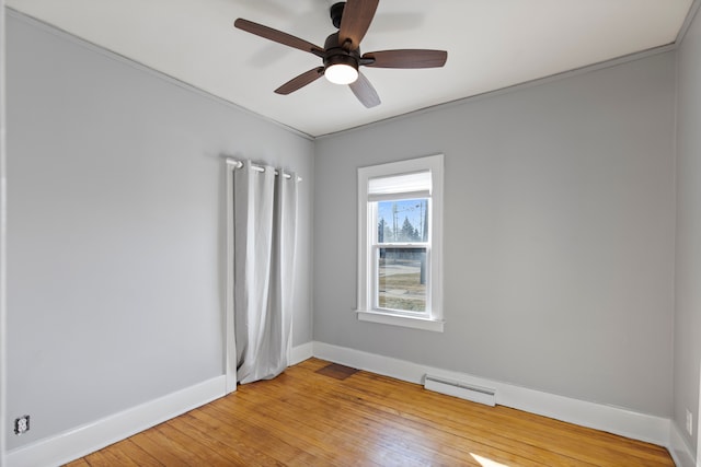 spare room with baseboards, visible vents, ceiling fan, and light wood-type flooring