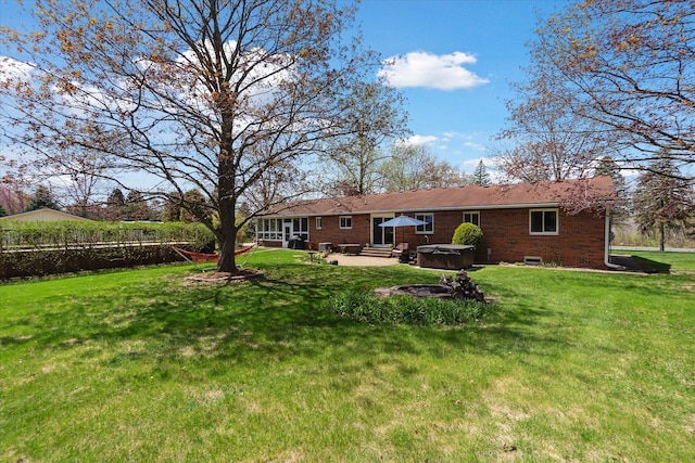 view of yard featuring a hot tub, entry steps, fence, and a patio area