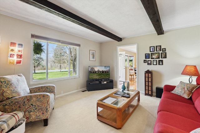 living room with carpet floors, beamed ceiling, and baseboards
