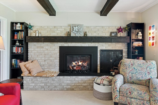 living room with a brick fireplace, beamed ceiling, and carpet floors