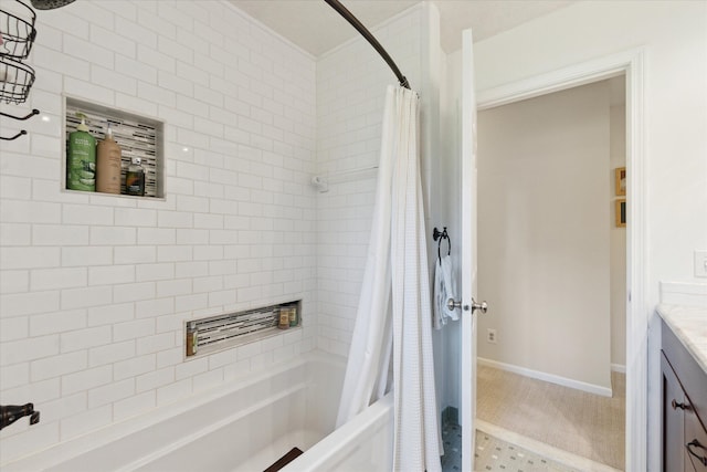 full bath featuring vanity, baseboards, and shower / bathtub combination with curtain