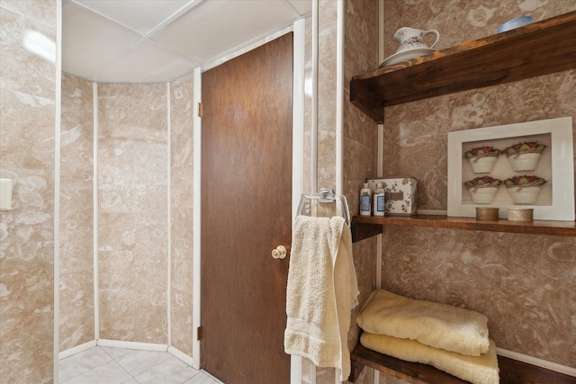 bathroom with baseboards and tile patterned flooring
