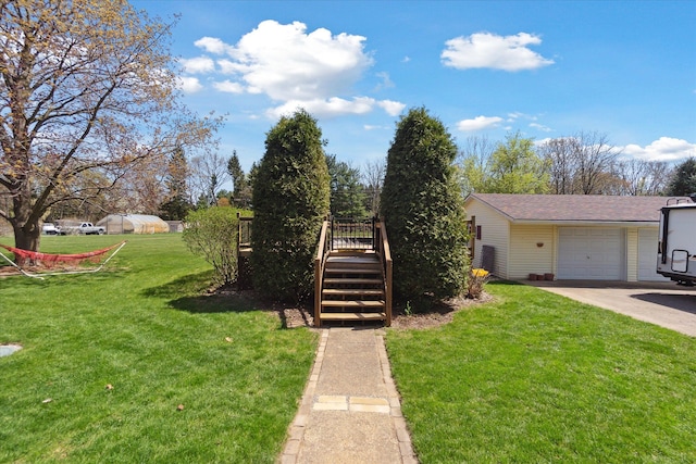 view of front facade with stairs, a front lawn, a garage, a wooden deck, and driveway