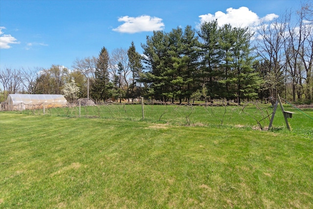 view of yard with an outdoor structure and a greenhouse