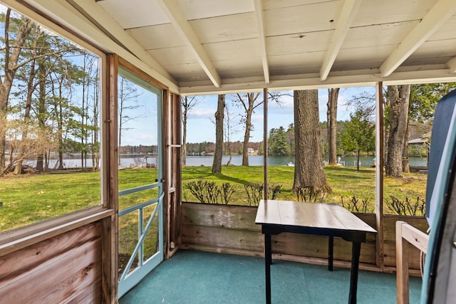 unfurnished sunroom with a water view and beam ceiling