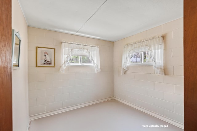 spare room featuring finished concrete floors