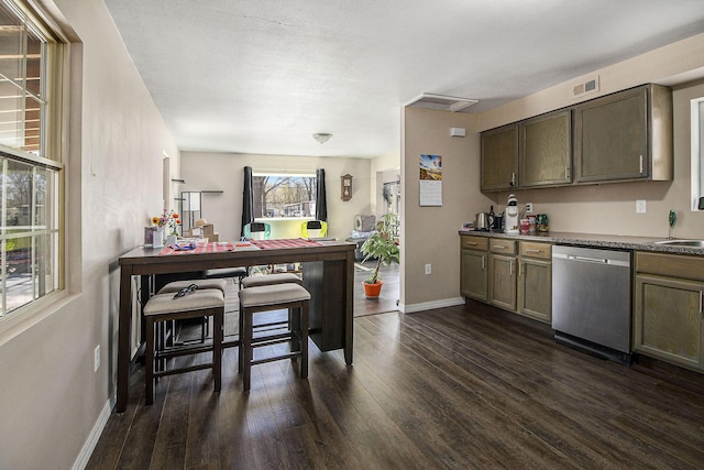 kitchen featuring stainless steel dishwasher, visible vents, baseboards, dark wood-type flooring, and a sink