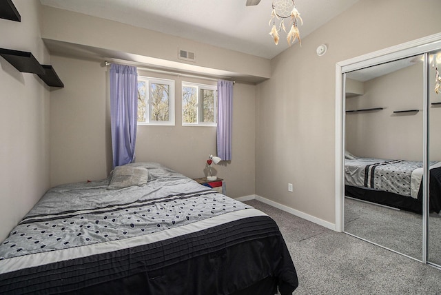 carpeted bedroom featuring a closet, baseboards, and visible vents