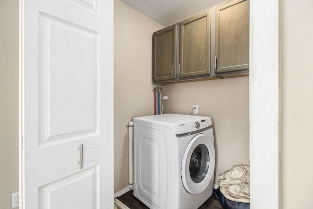 washroom featuring cabinet space and washer / clothes dryer