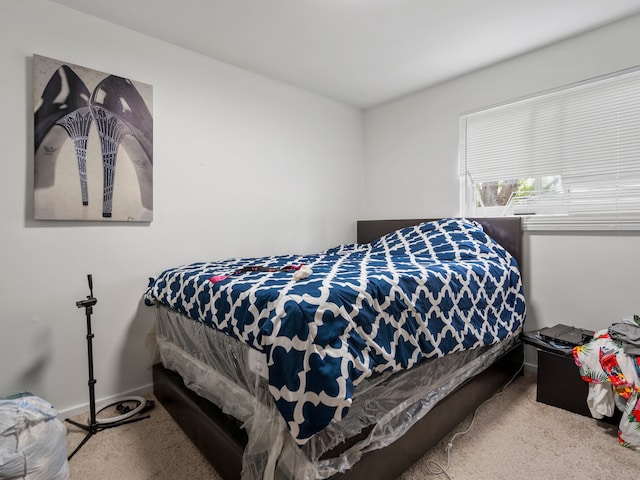 bedroom featuring carpet flooring and baseboards