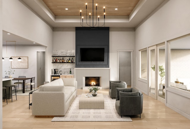 living room featuring a community bar, a raised ceiling, wooden ceiling, light wood-style floors, and a high ceiling