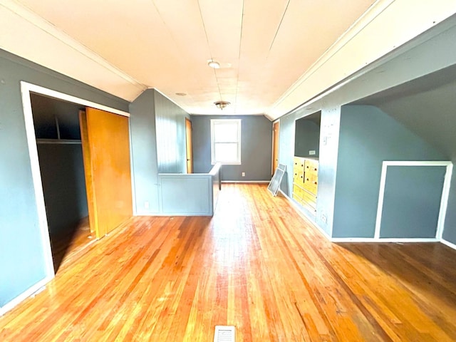 spare room featuring visible vents, baseboards, and hardwood / wood-style floors