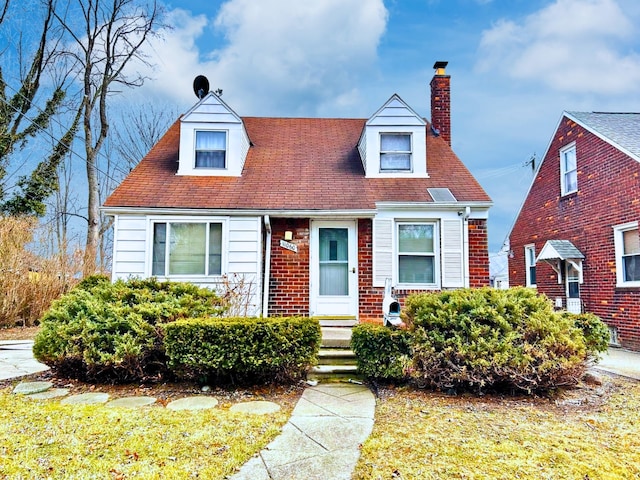 cape cod-style house with a chimney