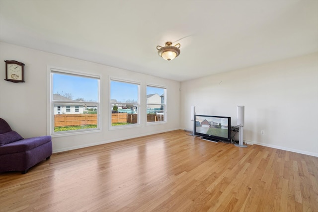 61 Old Carriage Ln, Lapeer, MI 48446 - unfurnished living room featuring light wood-style floors and baseboards