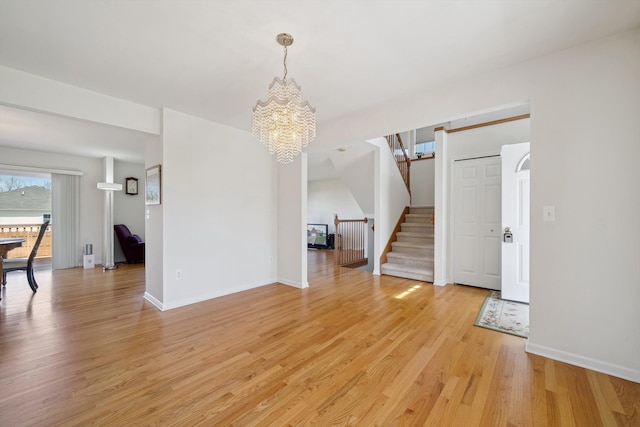 61 Old Carriage Ln, Lapeer, MI 48446 - interior space featuring baseboards, an inviting chandelier, stairway, and light wood-type flooring