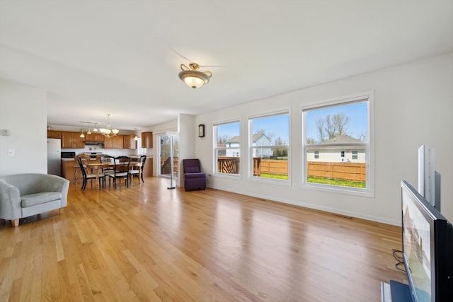 61 Old Carriage Ln, Lapeer, MI 48446 - living room featuring a notable chandelier, visible vents, and light wood-type flooring