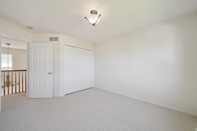 61 Old Carriage Ln, Lapeer, MI 48446 - unfurnished bedroom featuring visible vents, carpet, baseboards, and a closet