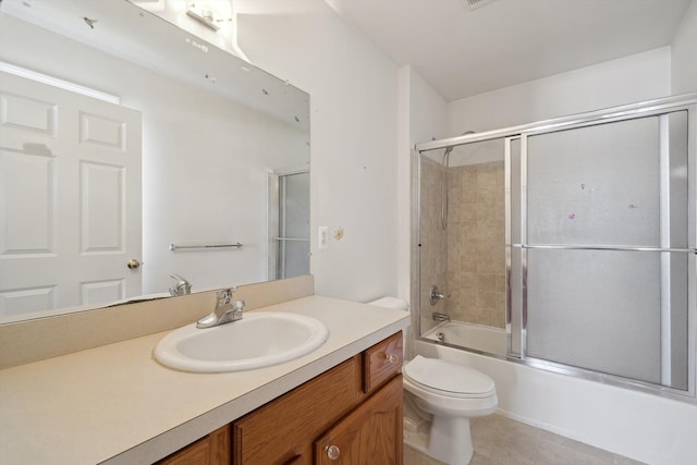 61 Old Carriage Ln, Lapeer, MI 48446 - full bathroom featuring vanity, bath / shower combo with glass door, tile patterned floors, and toilet