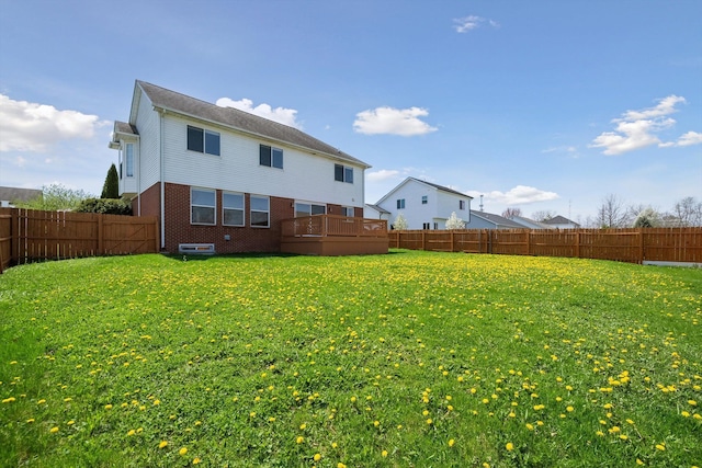 61 Old Carriage Ln, Lapeer, MI 48446 - back of property featuring brick siding, a fenced backyard, and a yard