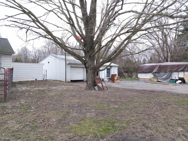 view of yard with fence and an outbuilding