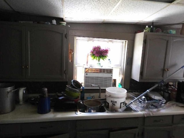 kitchen featuring light countertops, a drop ceiling, and cooling unit