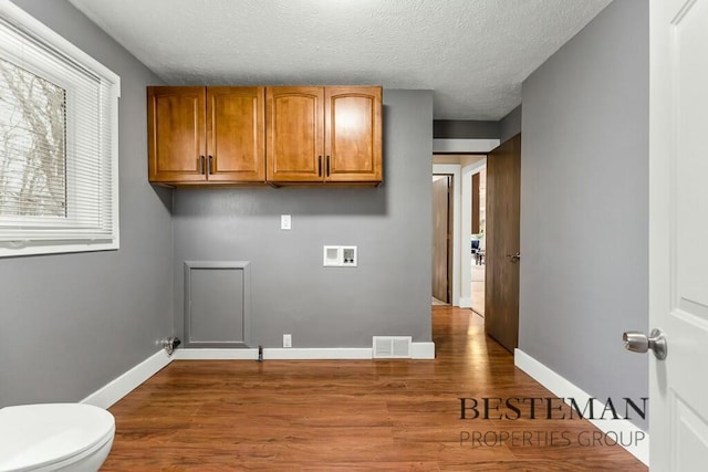 clothes washing area with laundry area, washer hookup, baseboards, and dark wood-style floors