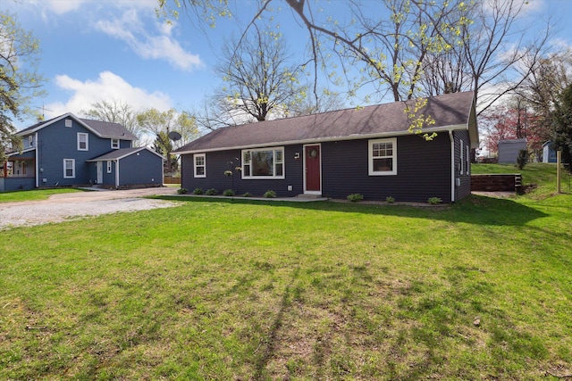 ranch-style home with driveway and a front yard
